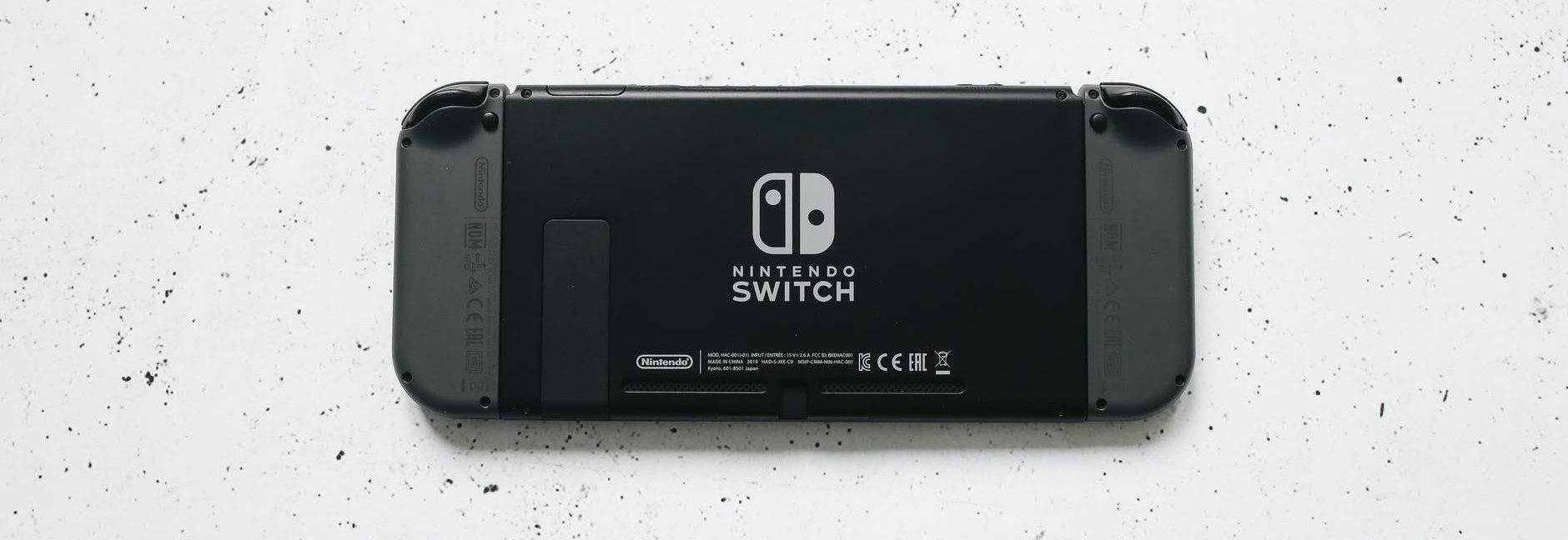 back of nintendo switch on marble surface