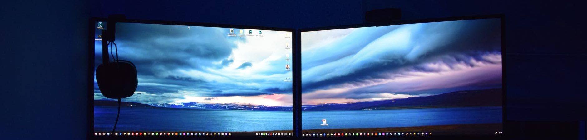 two computer flat screen monitors turned on